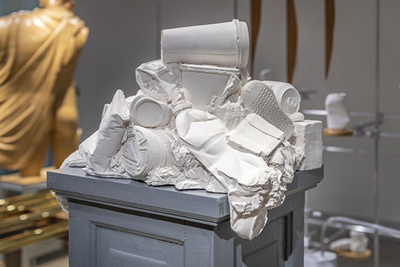 Detail of plaster casting of trash and detritus in sculpture The Best of All Possible Worlds